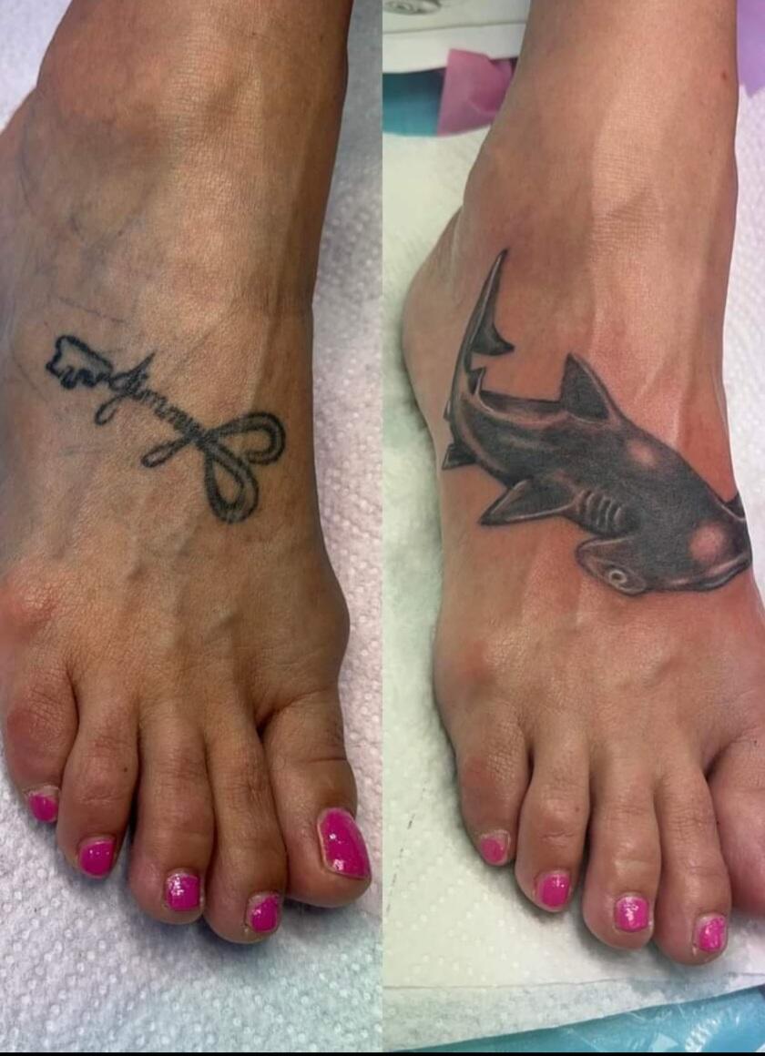 Shark tattoo and small cursive design on feet