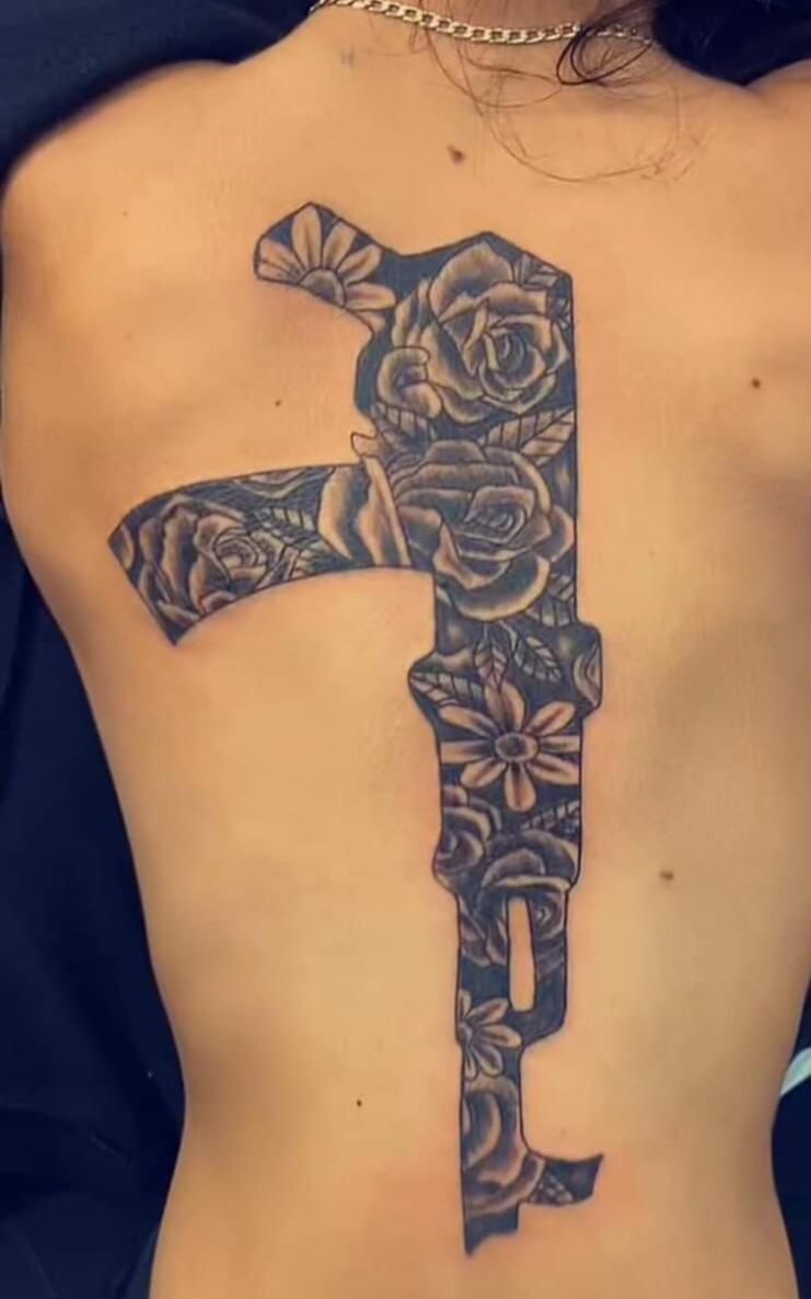 Detailed dark tattoo work extending along an arm